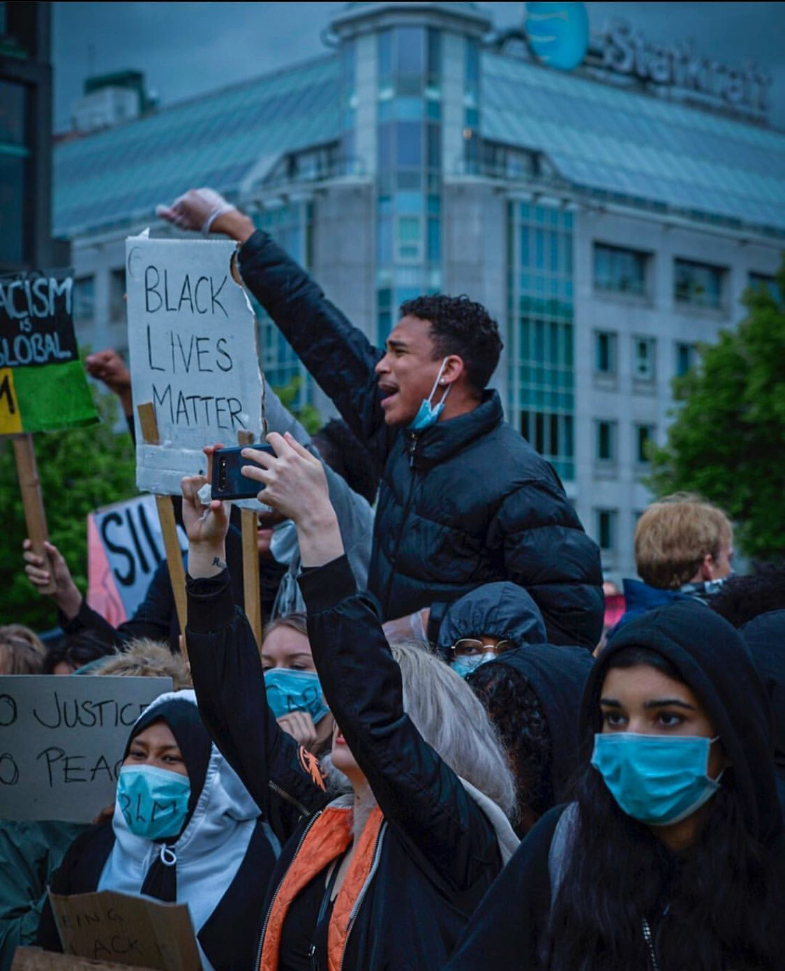 Joshua Arthur — Activism, Oslo, 2022 Joshua Arthur JJ elevated above BLM protest crowd Oslo Norway fist raised activism resistance Black Lives Matter 2022