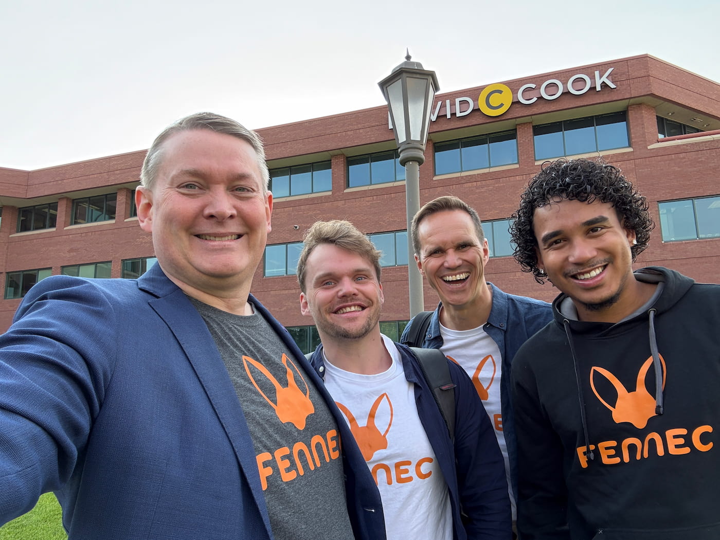 Joshua Arthur JJDREAMSS with Fennec publishing team in front of David C Cook building Colorado Springs USA summer 2025 international Christian media deal Lucid Dreams Productions multilingual entrepreneur